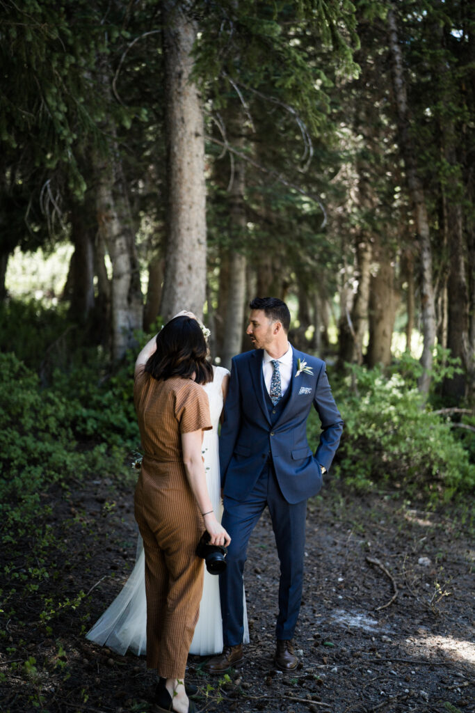 Elisha Braithwaite photographing a couple in a dark forest.