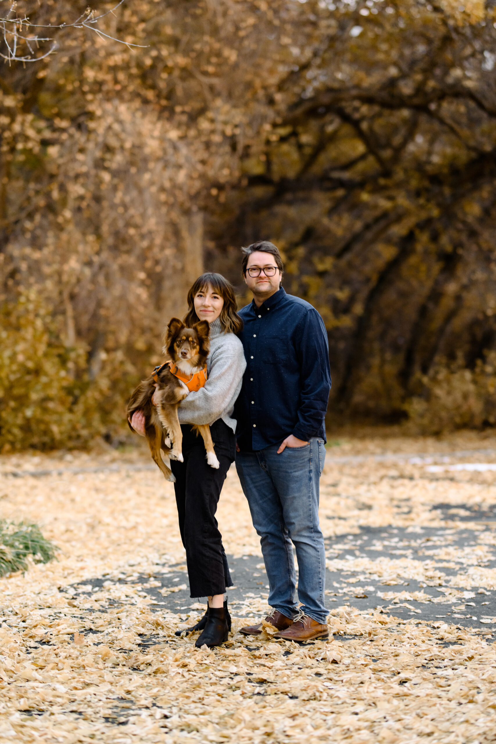 Todd West and Elisha Braithwaite in a fall scene holding their dog Canyon.