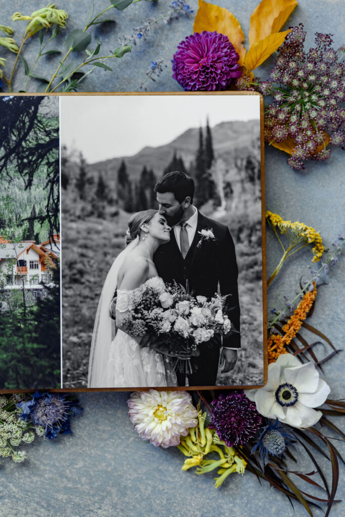 A single page of a photo album where a newly married couple is kissing.