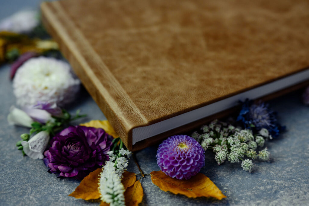 A close up of a brown leather flat lay photo album.