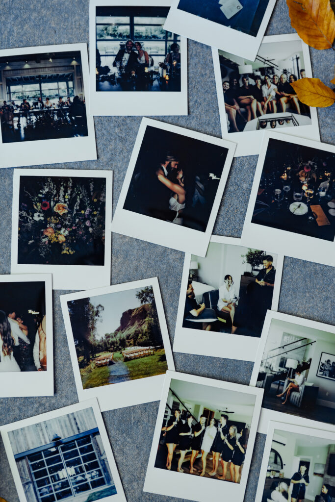 Different wedding scenes captured on Polaroids and arranged on a blue gray backdrop.