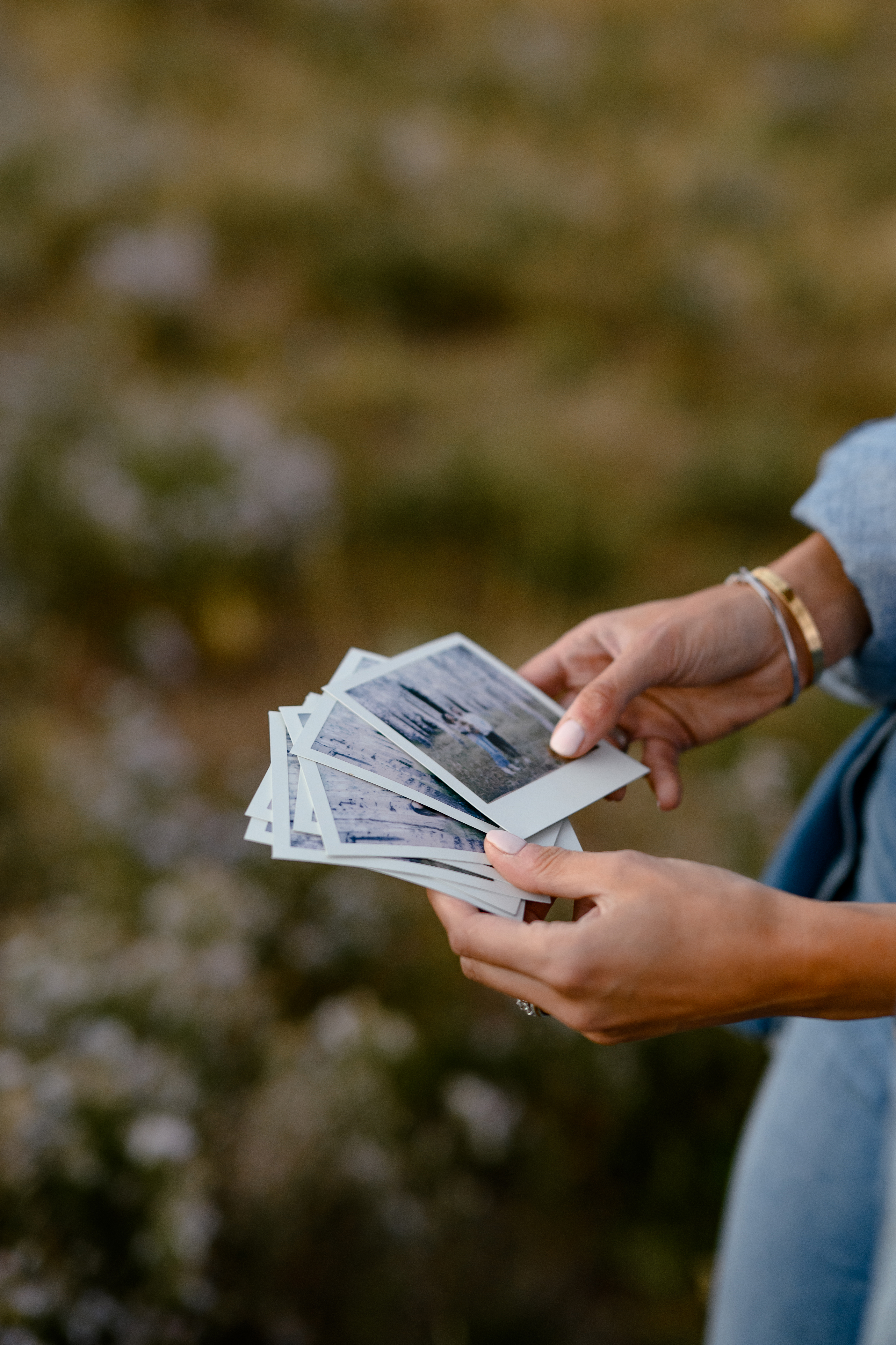 A couple admiring their Polaroid prints.